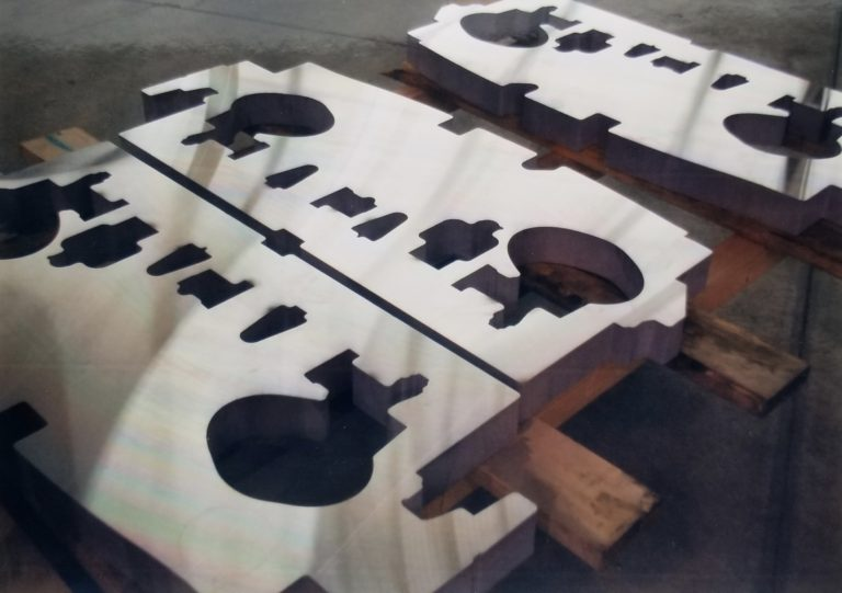 Waterjet-cut metal parts staged for delivery